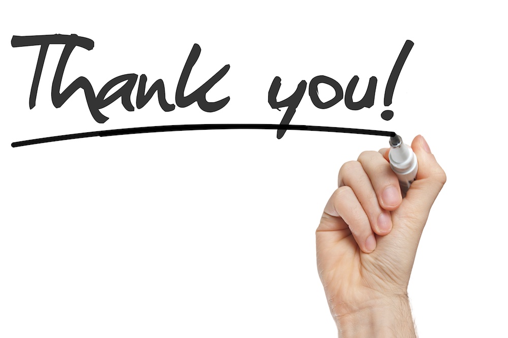 Hand writing Thank You with black marker on transparent wipe board.